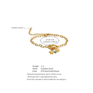 Gold bracelet with charms on a white background