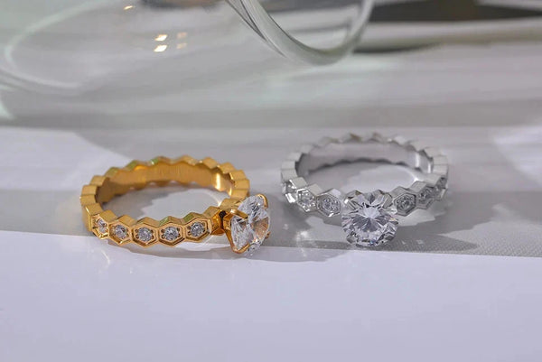 Gold and silver rings with diamond accents on a white surface
