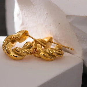 Gold braided ring on a white surface with 'Fashion Accessories' text above.