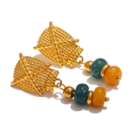 Gold earrings with green and orange beads on a white background