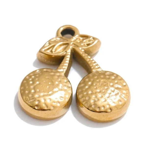 Gold pendant with textured surface on a white background