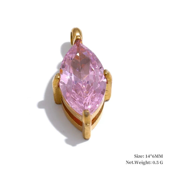 Pink teardrop-shaped gemstone in a gold setting on a white background