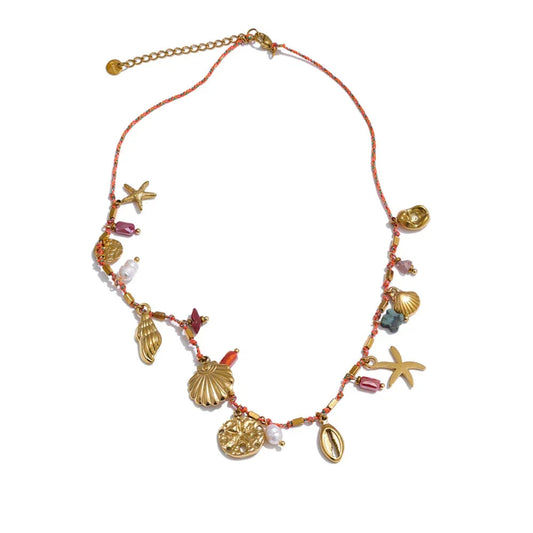 Necklace with seashell and starfish charms on a white background.