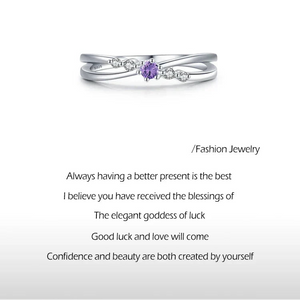 925 sterling silver ring with purple center gemstone and small clear crystals on a white background