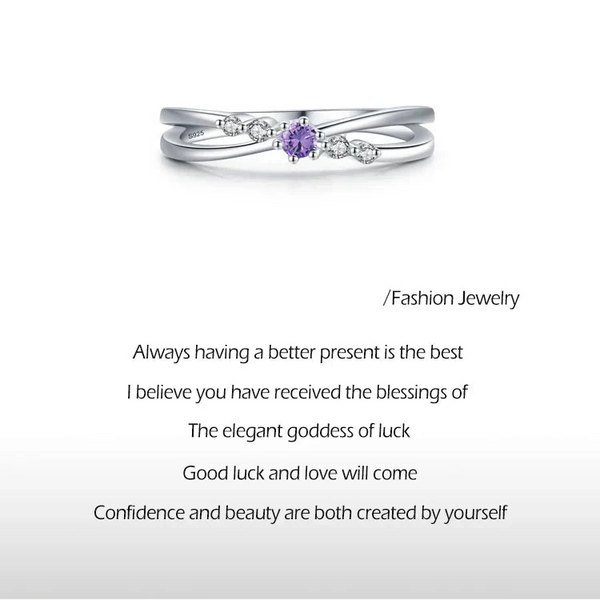 925 sterling silver ring with purple center gemstone and small clear crystals on a white background