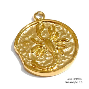 Gold pendant with a scorpion design on a white background