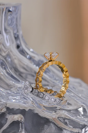 Gold and silver ring set on a decorative stone surface