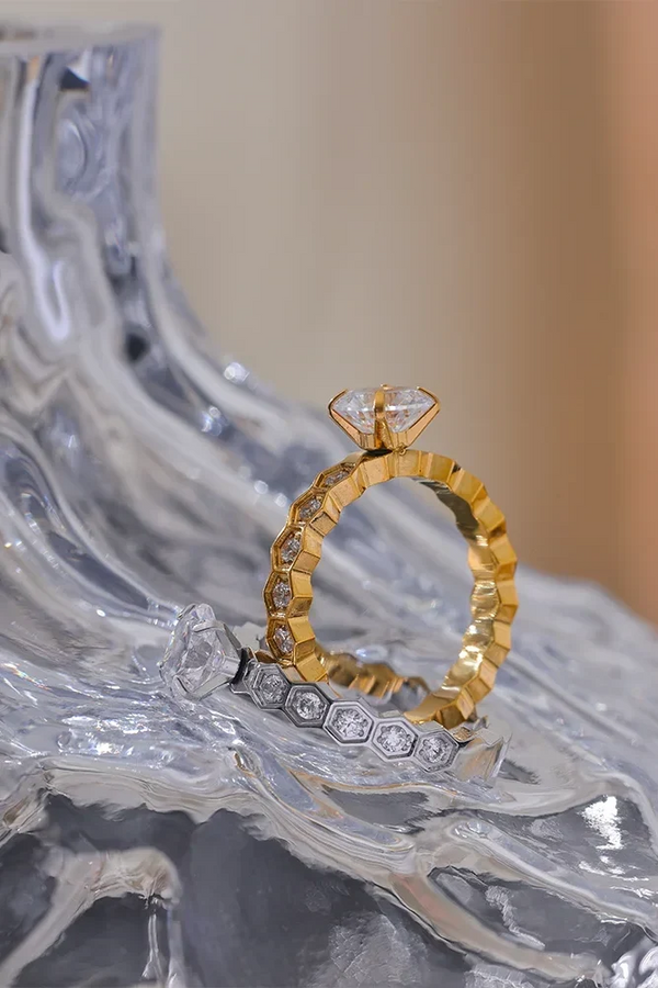 Gold and silver ring set on a decorative stone surface
