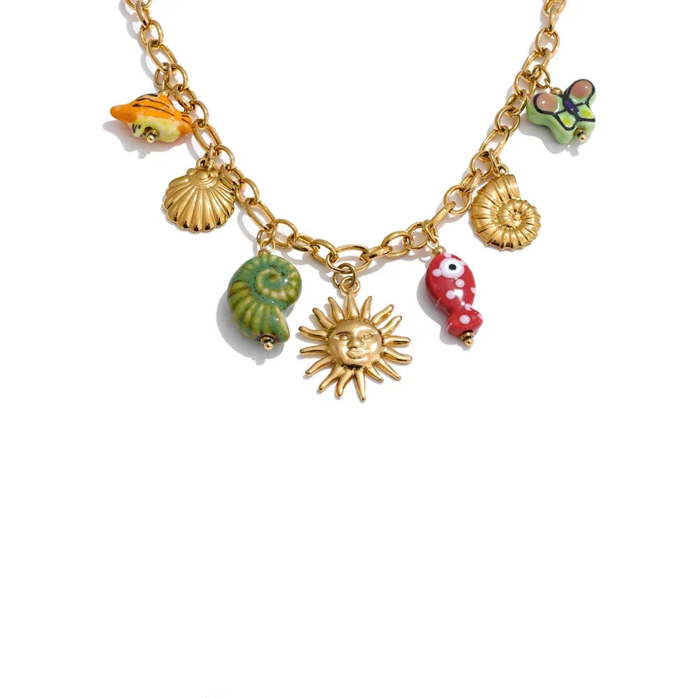 Gold necklace with colorful charms on a white background.