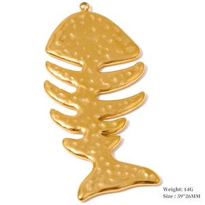 A gold-colored fish skeleton pendant with a textured, hammered finish, shown on a plain white background with product specifications text in the bottom right corner.