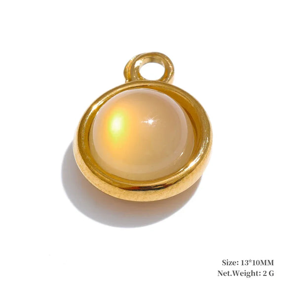 Gold pendant with a beige central stone on a white background