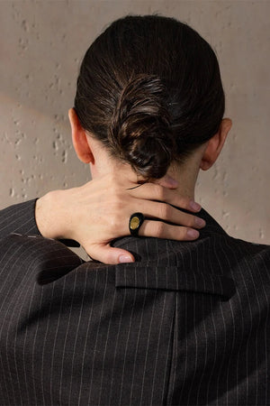 Person wearing a pinstripe suit with a neutral background