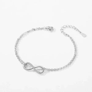 Sterling silver infinity symbol bracelet with delicate chain on white background