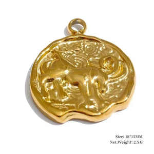Gold pendant with intricate design on a white background
