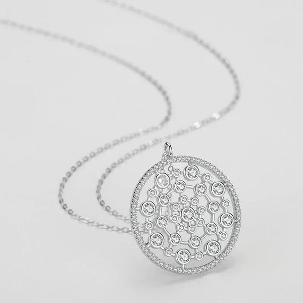 Silver necklace with a detailed pendant on a light gray background