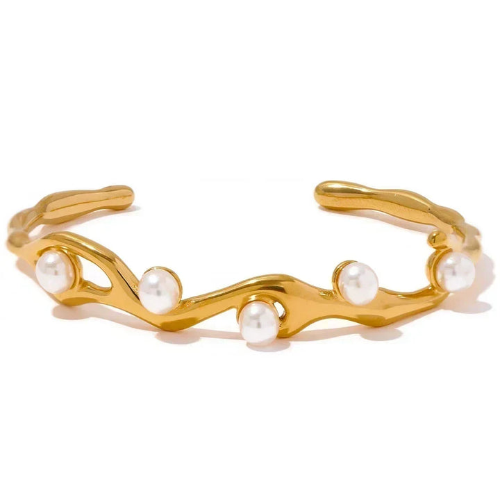 Gold bracelet with pearls on a white background