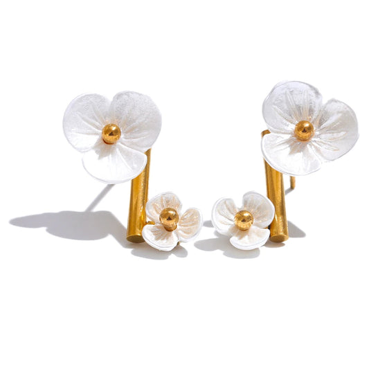 Floral earrings with gold accents on a white background.
