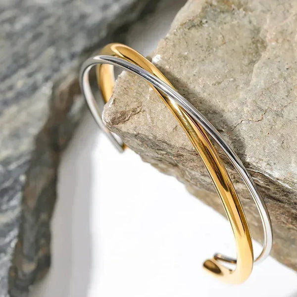 Elegant 925 silver and 18K gold-plated cuff bracelet on natural stone background