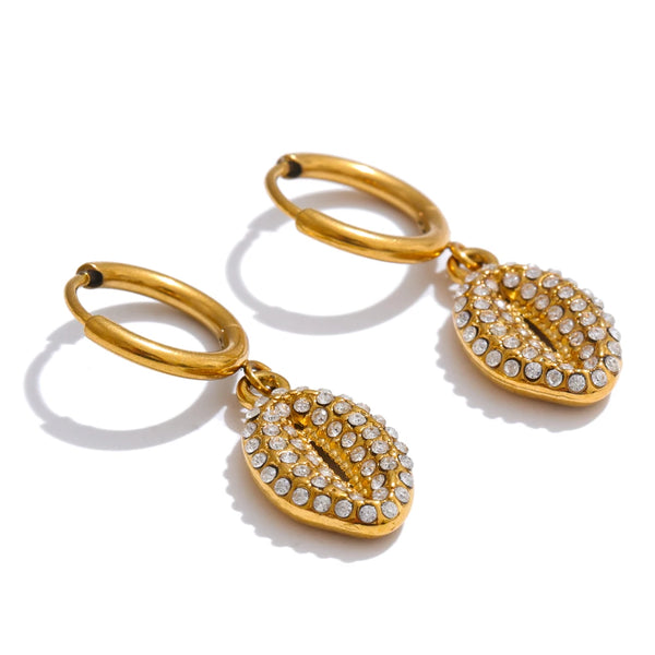 Gold hoop earrings with leaf-shaped pendants on a white background