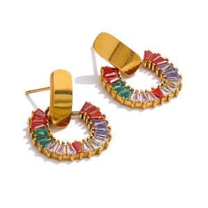 Gold hoop earrings with colorful gemstones on a white background.
