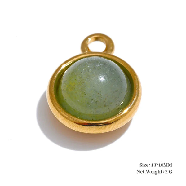 Gold pendant with a green stone on a white background