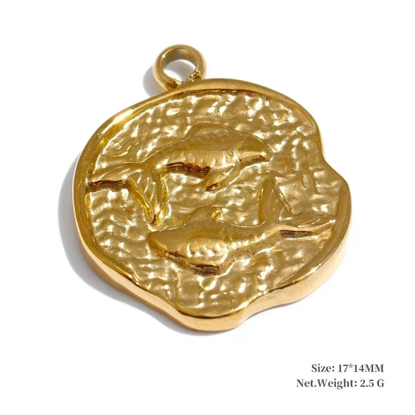 Gold pendant with a detailed design on a white background