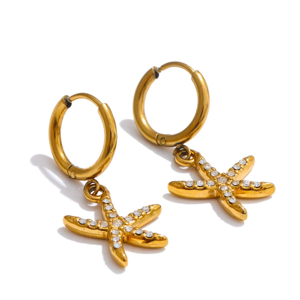 Gold hoop earrings with starfish charms on a white background