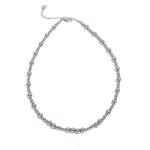 Silver beaded necklace on a white background