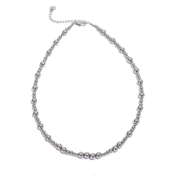 Silver beaded necklace on a white background