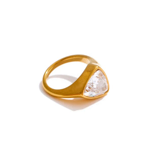 Gold ring with a triangular stone on a white background