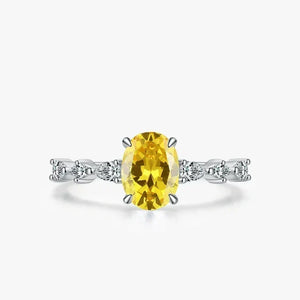 Amber Luxe Engagement Ring - TM & CO. JEWELS - Ring with a yellow gemstone and diamond accents on a white background.