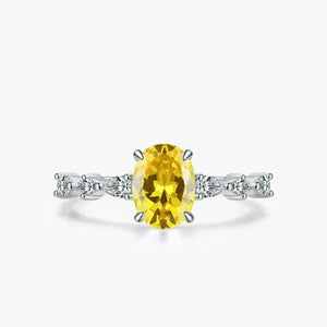 Amber Luxe Engagement Ring - TM & CO. JEWELS - Ring with a yellow gemstone and diamond accents on a white background.