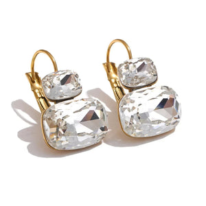 Gold and crystal earrings on a white background.