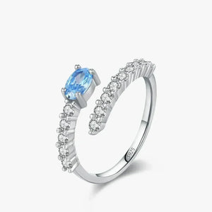 Silver ring with a blue gemstone on a white background