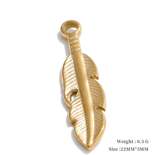 Gold feather-shaped pendant on a white background