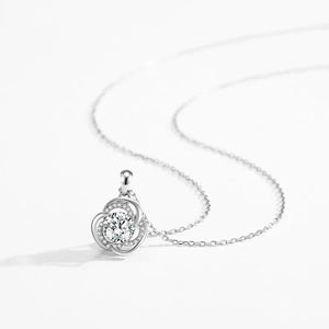 Silver necklace with a round pendant on a white background