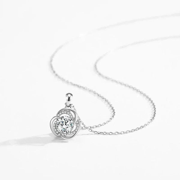 Silver necklace with a round pendant on a white background