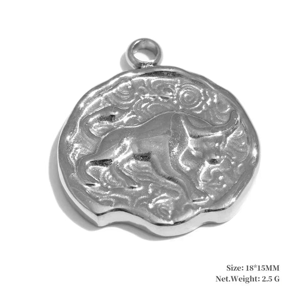 Silver pendant with engraved design on a white background