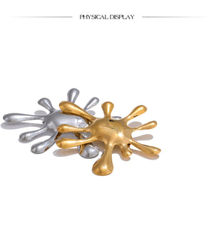Gold and silver abstract sculpture on a white background