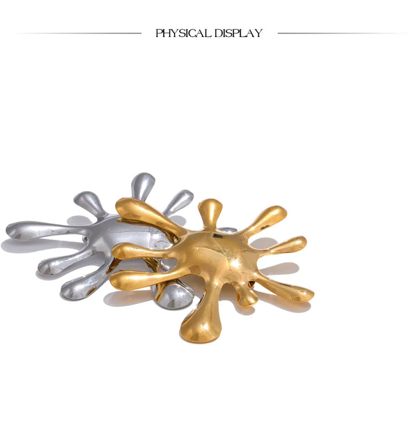 Gold and silver abstract sculpture on a white background