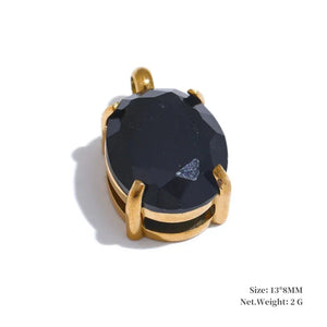Gold pendant with a large black gemstone on a white background