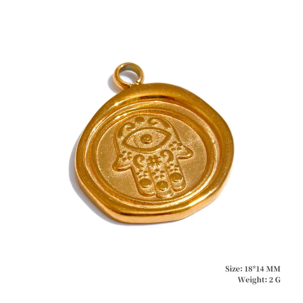 Gold pendant with Hamsa design on a white background