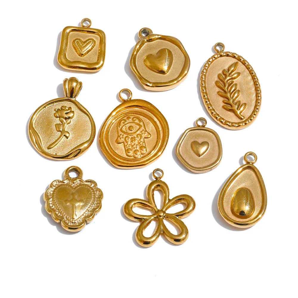 Collection of gold pendants with various designs on a white background.