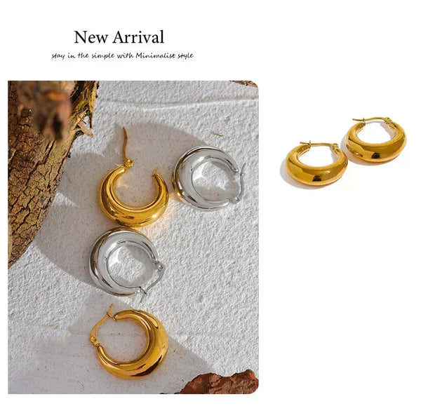 Gold and silver hoop earrings on a textured white surface with 'New Arrival' text.