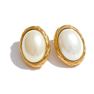 Pair of gold-framed pearl earrings on a white background.