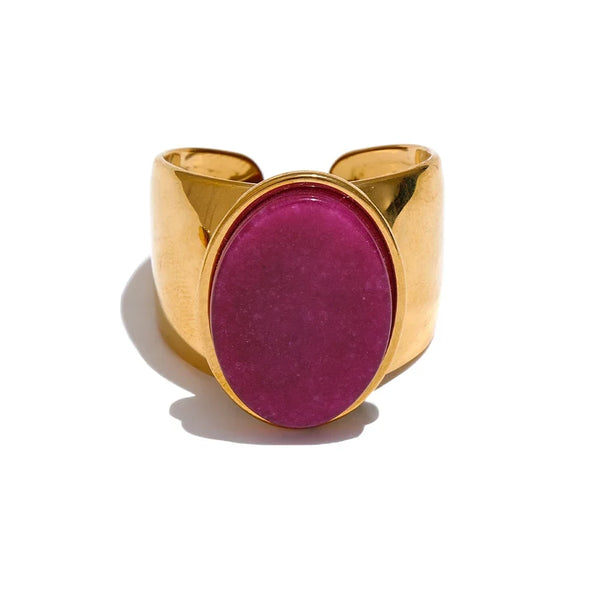 Gold ring with a pink stone on a white background