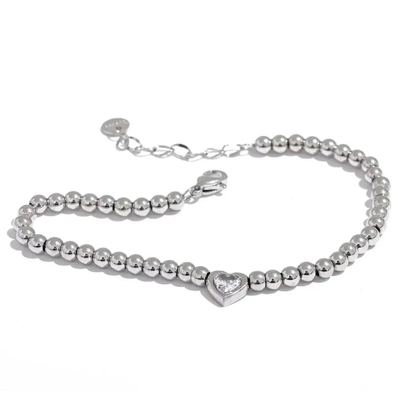 Steel beaded bracelet with heart-shaped crystal centerpiece on white background