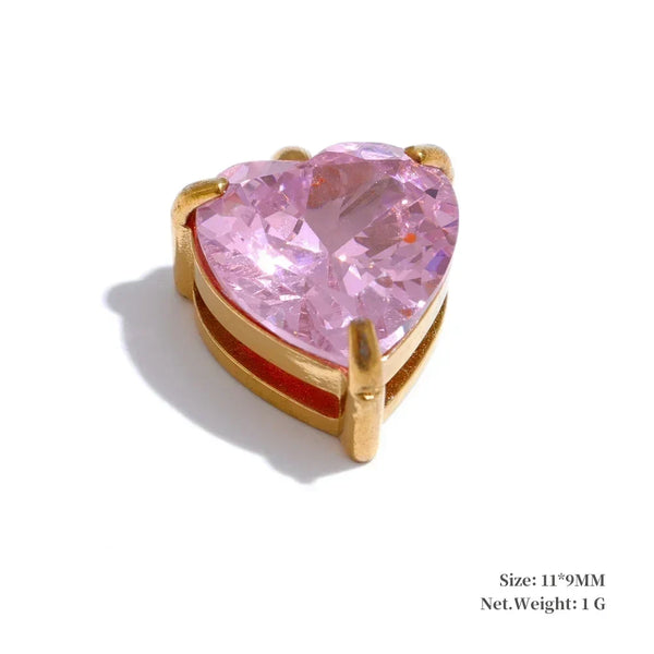 Heart-shaped pink gemstone in a gold setting on a white background
