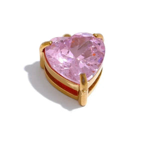 Heart-shaped pink gemstone in a gold setting on a white background