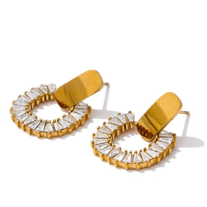 Gold hoop earrings with clear gemstones on a white background